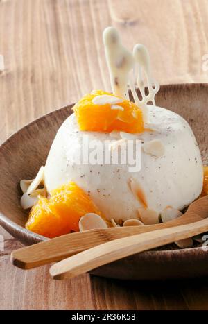 Panna cotta with orange fillets and almonds Stock Photo