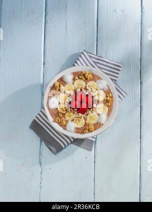 A Top View Of Sliced Crunchy Chocolate Tart With Hazelnuts On A Wooden 