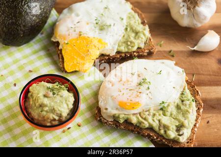 Multi-grain bread with guacamole and fried egg Stock Photo