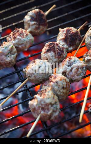 Meatballs on a grill rack Stock Photo - Alamy