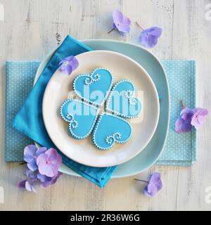Four heart-shaped biscuits decorated with blue and white icing Stock Photo