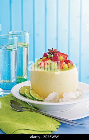 Strawberry & melon salad with ginger in an hollowed out melon Stock Photo