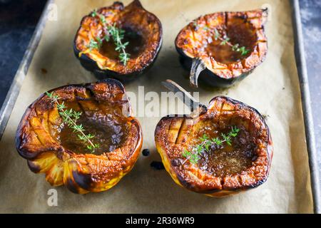 Roasted pumpkins with thyme on a baking sheet Stock Photo