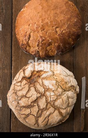 Two large loaves of farmhouse bread and a knife Stock Photo
