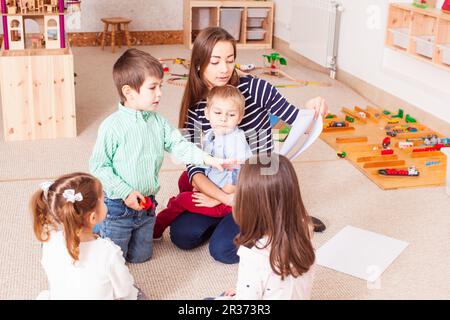 Teacher teaches preschoolers Stock Photo