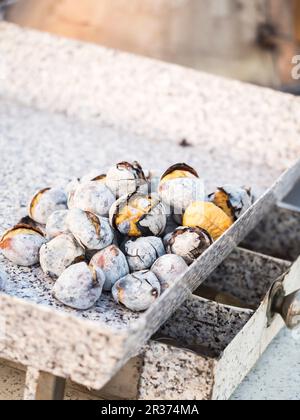 Roasted chestnuts sold on the streets of Lisbon, Portugal Stock Photo