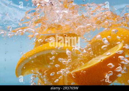 Orange slices in sparkling water Stock Photo