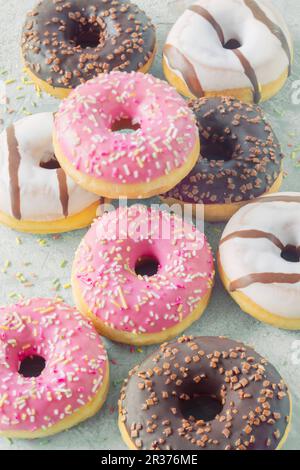 Doughnuts with various glazes and sugar sprinkles Stock Photo