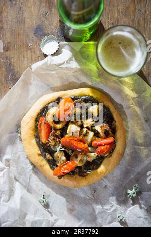 A mini pizza with squid and tomatoes Stock Photo