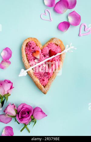 Heart shaped puff pastry tart filled with rose pastry cream for Valentine’s Day Stock Photo