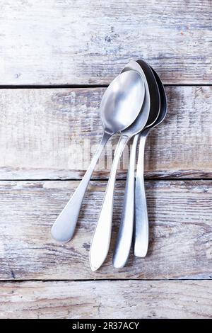 Several soup spoons on a wooden background Stock Photo