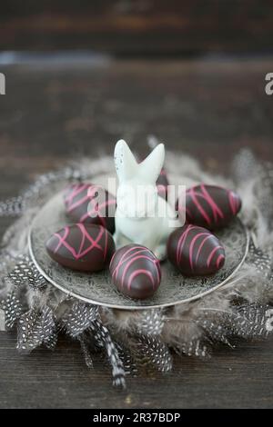Chocolate easter eggs and a porcelain rabbit Stock Photo