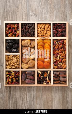 Mix Of Different Type Of Nuts On Wooden Background In Studio Photo 