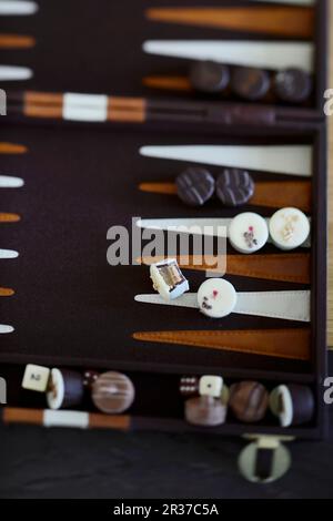 Various chocolates on a backgammon board Stock Photo