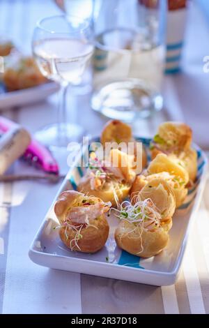 Spicy mini profiteroles filled with shrimps and sprouts Stock Photo