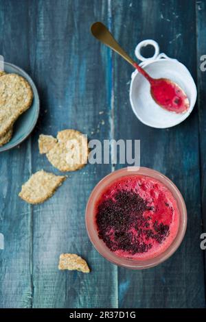 A beetroot smoothie with carrots, pineapple and chia seeds, with oat biscuits Stock Photo