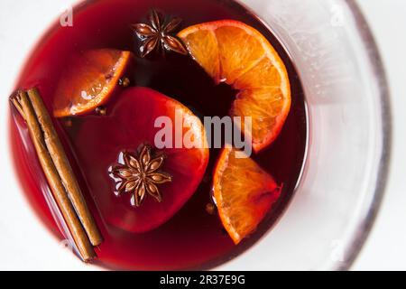 Mulled red wine with spices and fruit in a glass Stock Photo