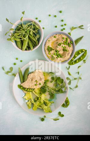 Pea houmous with peas, beans, and pea shoot, view from above Stock Photo