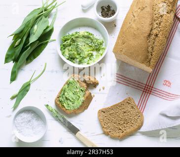 Homemade spelt and sesame seed bread with wild garlic butter Stock Photo