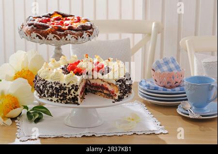 Apple cake and almond cake on cake stands Stock Photo