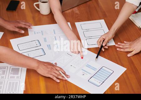 Closeup image of project manager and ui and ux designers discussing ideas for new interface Stock Photo