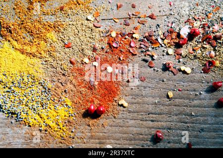 Various peppers and spices on a wooden surface Stock Photo
