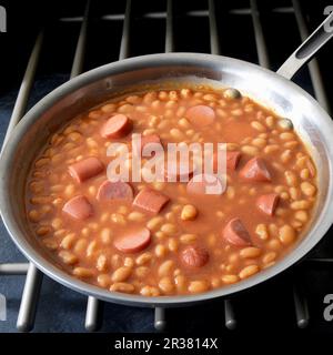 Frankfurters with baked beans in skillet Stock Photo
