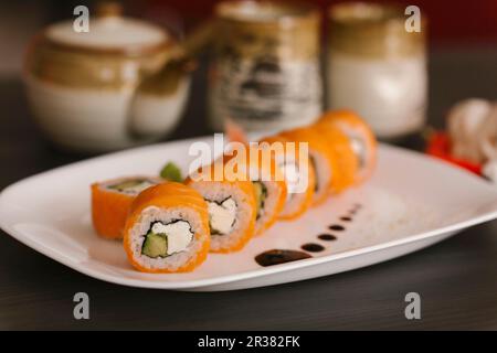 Salmon sushi with fresh cheese on a serving platter Stock Photo