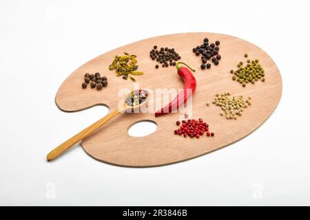 Palette of various spices on wooden palette isolated on white Stock Photo