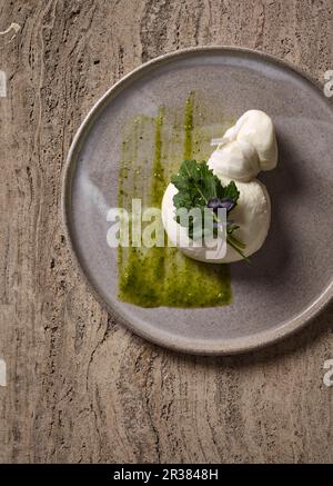 Burrata cheese with cabbage leaves Stock Photo