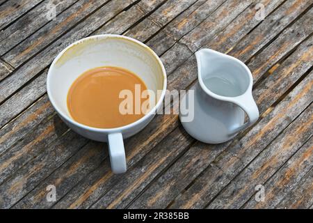 One finished cup of latte coffee on bamboo table Stock Photo