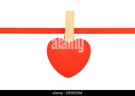 Red wooden heart at ribbon isolated on white Stock Photo