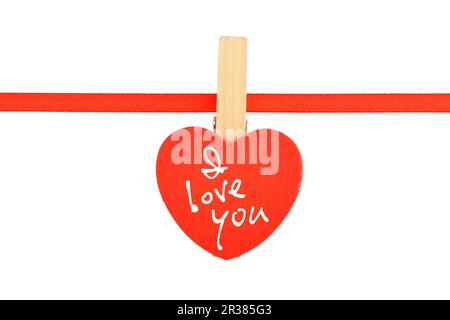 Red wooden heart at ribbon isolated on white Stock Photo