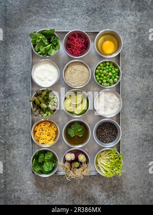 Ingredients for making quinoa burgers and muffins in small bowls Stock Photo