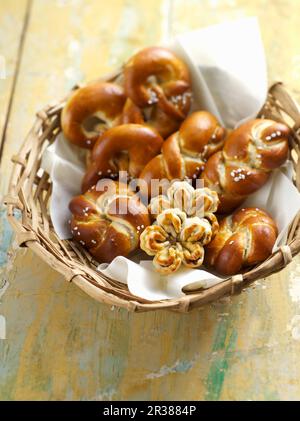 Lye bread rolls in a bread basket Stock Photo