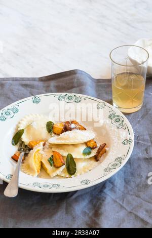 Roasted pumpkin and ricotta ravioli with sage, butter and parmesan cheese Stock Photo