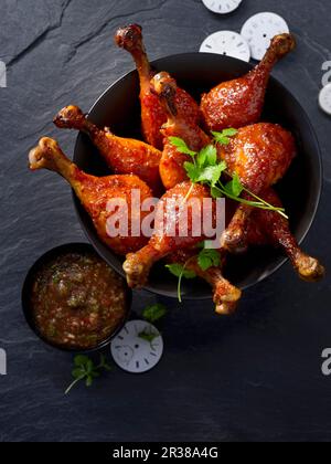 Glazed corn fed chicken drumsticks with a tamarind dip Stock Photo