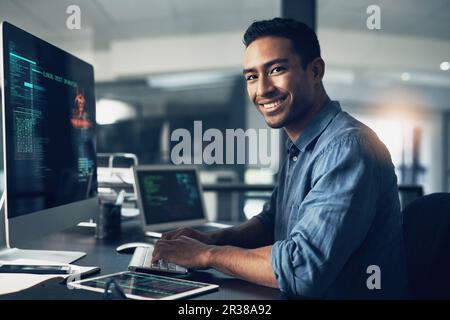 Portrait, man and smile of programmer on computer in office workplace at night. IT, face and male coder or person programming, coding and writing for Stock Photo