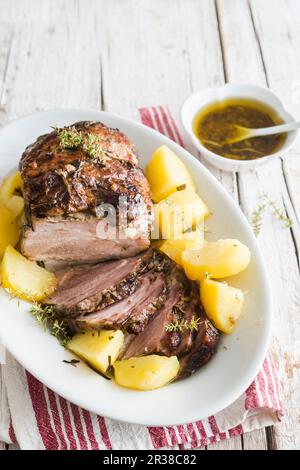 Crown Roast of Pork with Potatoes on a Platter Stock Photo