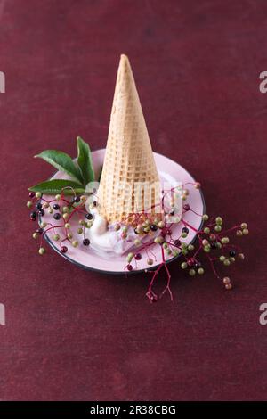 An upside down ice cream cone with elderberry ice cream Stock Photo