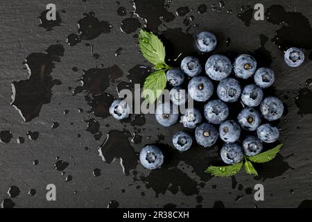 Close up washed fresh blueberries on black board Stock Photo
