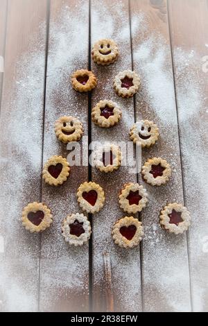 Christmas jam biscuits arranged in a tree shape on a wooden surface Stock Photo