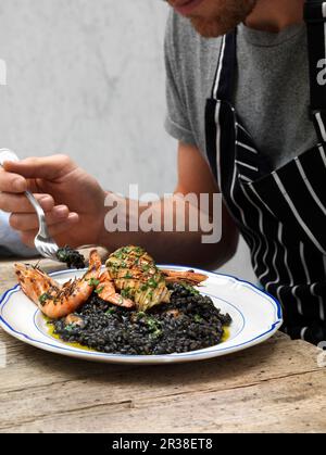 Black octopus risotto with seafood Stock Photo