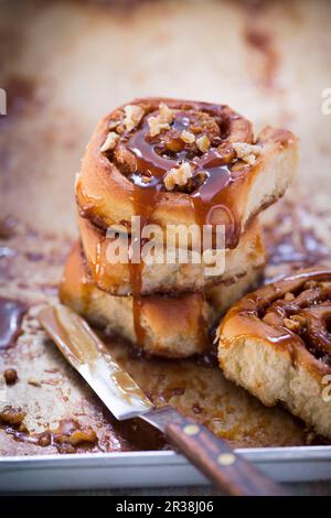 Cinnamon rolls with chopped nuts and caramel sauce Stock Photo