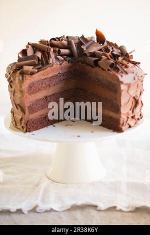 A three-layer chocolate cream cake, sliced Stock Photo