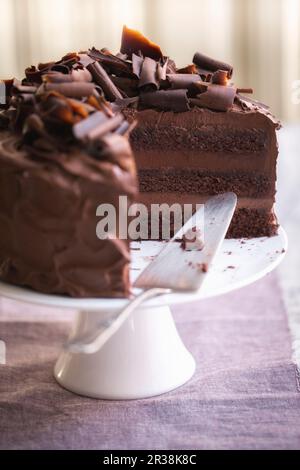 A three-layer chocolate cream cake, sliced Stock Photo