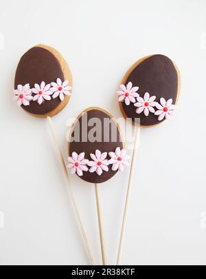 Three Decorated Easter Egg shaped cookies on a stick Stock Photo