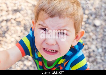 Emotional crying baby face, close up kid Stock Photo