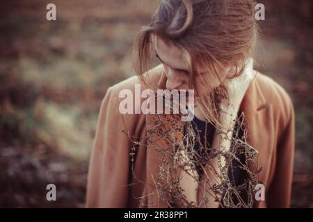 Lonely girl on a walk in the fall field Stock Photo