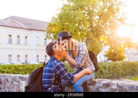 Portrait of romantic couple sitting face-to-face, love Stock Photo